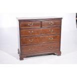 An early 19th Century mahogany chest of drawers The rectangular moulded top with chequered inlay