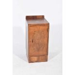 A 1930's Art Deco walnut pot cupboard The single door enclosing a fitted drawer with inset swing