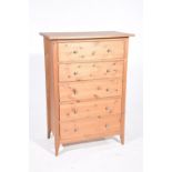A modern pine chest of drawers The five drawers each applied with metal knob handles raised on