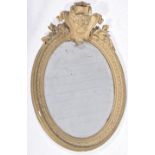 A 19th Century gilt Gesso oval wall mirror The oval bevelled mirror plate adorned with a cockbeaded