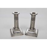 A pair of Victorian Silver candlesticks Each of the square section bases,