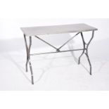 A vintage industrial stainless steel garden table The plain top raised on flattened exterior