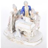 A 20th Century Dresden figure group Of a lady pianist and lady harpist with attendant gentleman