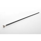 A late Victorian ebonised gentleman's walking cane The tapered ebonised stick surmounted by a white