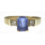 A tanzanite and diamond three stone ring The emerald-cut tanzanite,