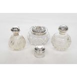 A Collection of Silver topped ladies perfume bottles and dressing pots To include a pair of cut
