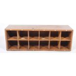 A vintage wall mounted wooden pigeon hole cabinet With twelve pigeon holes numbered 31 - 42,