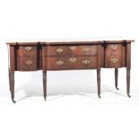 A George III mahogany and satinwood crossbanded sideboard The shaped top centered with an inlaid