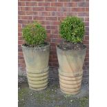 A pair of reconstituted stone planters Each of tapered cylindrical form,