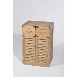 A contemporary Campaign style light oak storage cabinet with brushed metal embellishments and two
