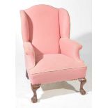 A George II style wing back fireside armchair,