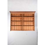 A pine dresser rack With a moulded cornice above three graduated shelves with a central upright,
