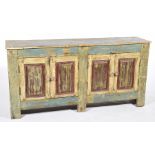 A painted country French style sideboard With a rectangular two plank top above two pairs of