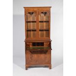 A good quality Regency style mahogany secretaire bookcase Having a dentil cornice above a pair of