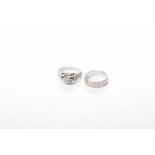 An 18k white gold diamond set ring and wedding band Each ring decorated with the bark effect,