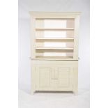 A painted hardwood kitchen cabinet The upper section with three enclosed shelves above a