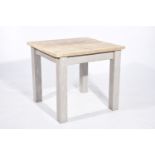 A small rustic pine kitchen table The reclaimed plank top supported on four substantial painted