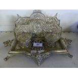 Early 20th Century continental brass desk stand, decorated with foliate scroll,