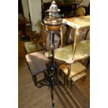 A late 19th/early 20th Century cast iron adjustable oil lamp (converted to electric),