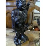 A late 19th/early 20th Century Chinese hardwood carved figure, 38cm high.