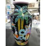 A 20th Century Chinese Famille Noir baluster vase decorated with figures and foliage.