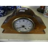 A small Edwardian mantel clock in mahogany and inlaid case.