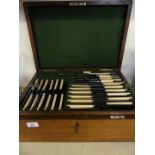A Walker & Hall Sheffield oak cased canteen, of silver-plated steel and ivorine handled cutlery,