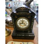 A Victorian marble and black slate mantel clock, fitted with brocot escapement.