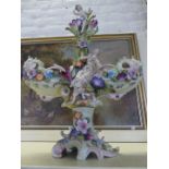 A 20th Century Continental porcelain centre piece decorated with figures and flowers.