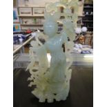 A 20th Century Chinese simulated jade or glass model of female figure, amongst foliage 27cm high.