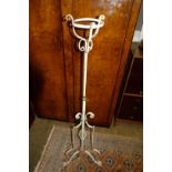 A vintage white painted metal adjustable oil lamp stand.