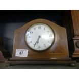 A small Edwardian mantel clock in mahogany, and lined inlaid case fitted with Swiss movement,