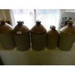 A group of five slab seal/impressed stoneware flagons marked I T & J Gaskarth Altrincham