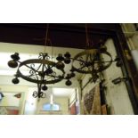 A pair of metal Jacobean revival hanging chandeliers.