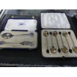 A cased set of six hallmarked silver and enamel finished coffee spoons with beaded ends,