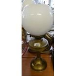 A 20th Century brass based oil lamp with a plate glass shade.