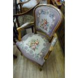 A reproduction Louis XV style armchair, upholstered in a tapestry floral material.