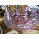 A modern cranberry and clear glass pedestal tazza