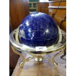 A modern hardstone and shell inlaid globe on brass finished stand.