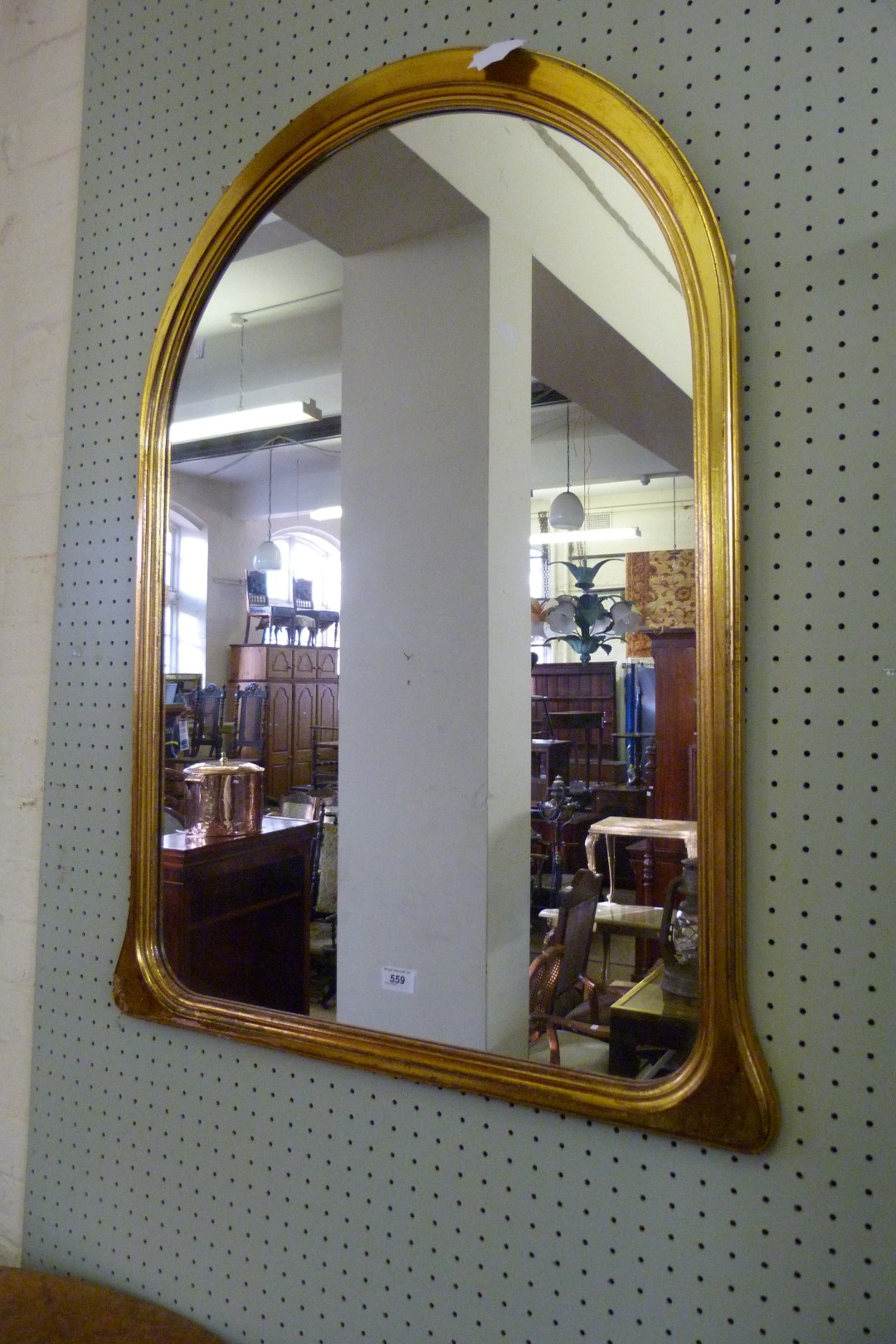 A decorative gilt framed over mantel mirror.