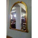 A decorative gilt framed over mantel mirror.