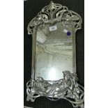 A contemporary wall mirror in Art Nouveau silvered finished frame.