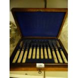 A walnut cased set of fish knives and forks.