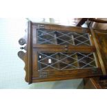 A good quality solid oak Old Charm hanging corner cabinet, having two leaded glazed doors.