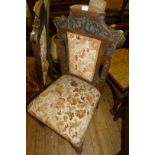 A pair of carved oak Flemish style hall chairs.