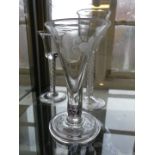 Two contemporary air twist stem glasses together with a further ale glass etched with barley and