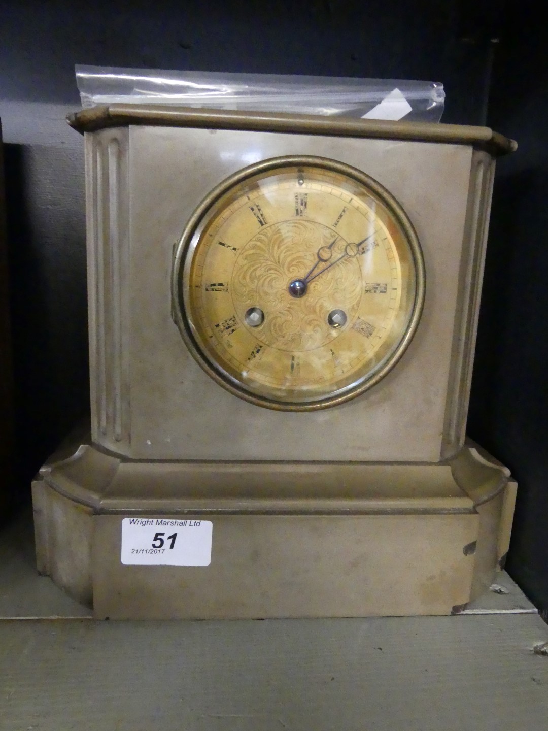 A Victorian grey slate mantel clock, complete with key and pendulum.