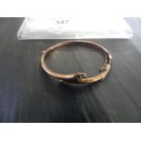 A 9K gold snake bangle, the hinged bangle with pink stone eyes, stamped .375, approx. weight 5g.