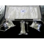 A Birmingham hallmarked silver three piece cruet set, in fitted case.