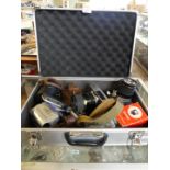 An aluminium flight case containing various cameras to include Canon, Praktica and others.